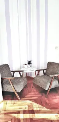 a living room with two chairs and a table at Apartman Lucija in Livno