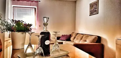 a living room with a bottle of wine on a table at Apartman Lucija in Livno