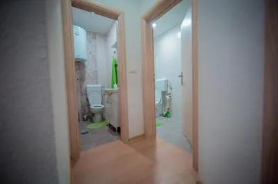 a bathroom with two toilets and two urinals at Apartman Lucija in Livno