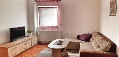a living room with a couch and a tv at Apartman Lucija in Livno
