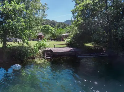 a wooden bridge over a body of water at Guest House VEZ Bihac in Bihać
