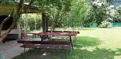 a picnic table and a bench in a park at Guest House VEZ Bihac in Bihać