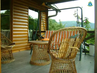 a patio with chairs and a table on a porch at Guest House VEZ Bihac in Bihać