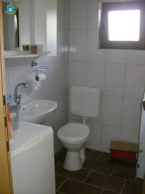 a bathroom with a white toilet and a sink at Guest House VEZ Bihac in Bihać