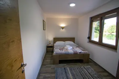 a bedroom with a bed and a window and a door at Villa Sabina in Lohovo