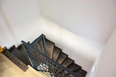 a staircase in a house with a black rail at Villa Sabina in Lohovo