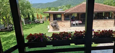 a view from a window of a house with flowers at Holiday Home Emir in Račić