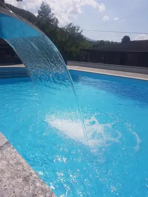 a water fountain in a swimming pool at Holiday Home Emir in Račić