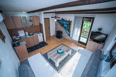 a living room with a couch and a table at Holiday Home Emir in Račić