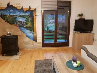 a living room with a painting on the wall at Holiday Home Emir in Račić
