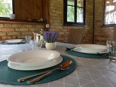 a table with plates and utensils on top of it at Holiday Home Emir in Račić