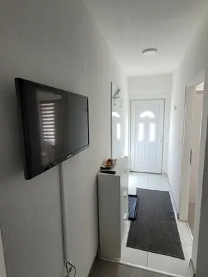 a room with a flat screen tv on the wall at Apartmani ELEGANCE Tuzla in Tuzla