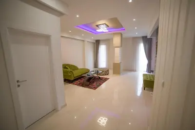 a living room with a green couch and a purple ceiling at Hotel Urban in Bužim
