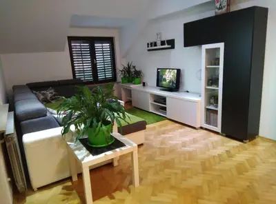 a living room with a couch and a tv at Receptiva BL in Banja Luka
