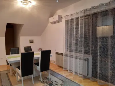 a room with a table and chairs and a window at Receptiva BL in Banja Luka