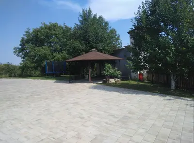 a pavillion with a brown umbrella in a yard at Receptiva BL in Banja Luka
