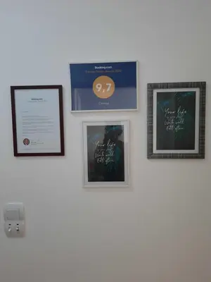 a wall with three pictures on a wall at Omega in Doboj