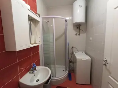 a bathroom with a shower and a sink and a toilet at Omega in Doboj