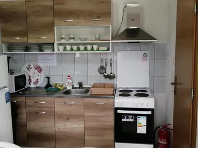 a kitchen with a stove and a sink at Amina River Apartment in Bihać