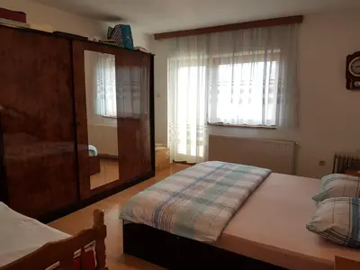 a bedroom with a bed and a large mirror at Kuca za odmor Sarcevic in Prozor