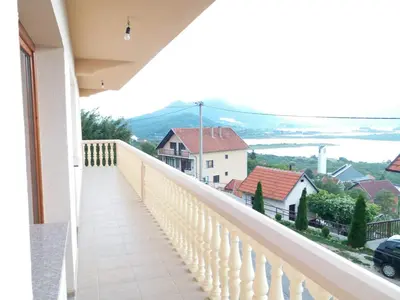 a balcony of a house with a view of the water at Kuca za odmor Sarcevic in Prozor