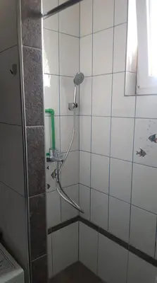 a shower with a hose in a bathroom at Prenociste Sana Sanski Most in Sanski most