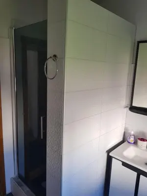a shower in a bathroom with a sink and a mirror at Prenociste Sana Sanski Most in Sanski most