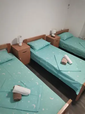 two twin beds in a room with blue sheets at Prenociste Sana Sanski Most in Sanski most