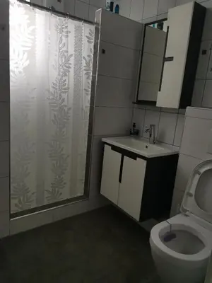 a bathroom with a shower and a toilet and a sink at Prenociste Sana Sanski Most in Sanski most