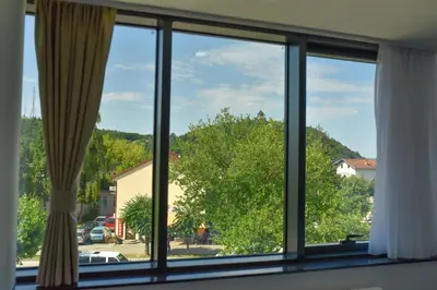 a window with a view of a tree at Motel Grand in Velika Kladuša