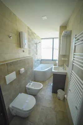 a bathroom with a toilet and a sink and a tub at Motel Grand in Velika Kladuša