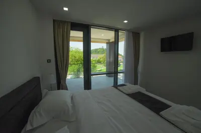 a bedroom with a bed and a large window at Motel Grand in Velika Kladuša