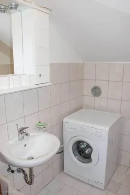 a bathroom with a washing machine and a sink at Green Forest Visoko in Visoko