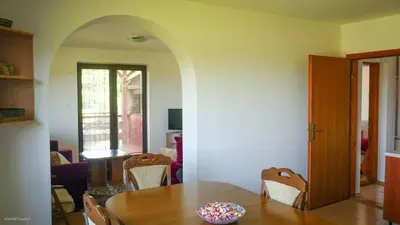 a dining room with a table and chairs at Green Forest Visoko in Visoko