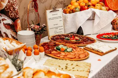 a table topped with plates of food and fruit at Hotel Park Doboj in Doboj