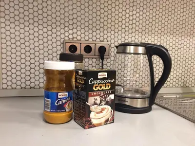 a mug of beer next to a box of coffeeaband at Apartment Galerija in Tuzla