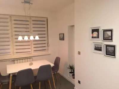 a dining room with a white table and chairs at Apartment Galerija in Tuzla