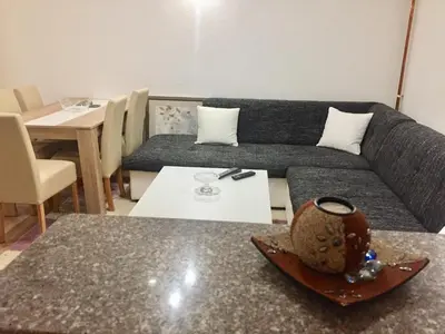 a living room with a couch and a table at Apartman AS in Bihać