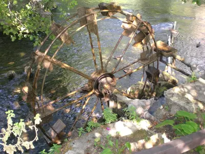 a wheel of a bike sitting in the water at Apartman AS in Bihać