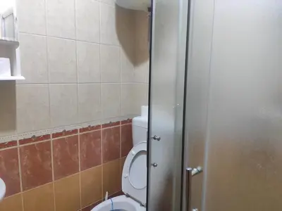 a bathroom with a toilet with the door open at Apartman AS in Bihać