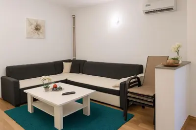 a living room with a couch and a table at Apartman AS in Bihać