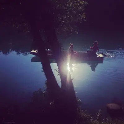 a group of people sitting on a boat in the water at Una holiday house in Bihać