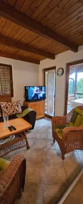 a living room with a couch and a tv at Green Oasis in Bihać
