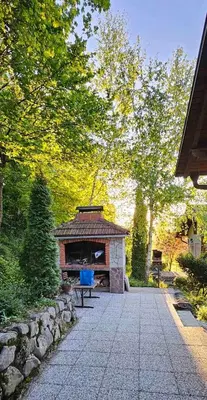 a stone shelter with a bench in a garden at Green Oasis in Bihać