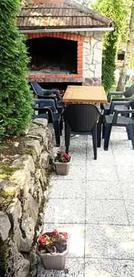 a patio with a table and chairs and a piano at Green Oasis in Bihać