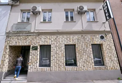 a man walking out of a building at Hotel Ideja in Banja Luka