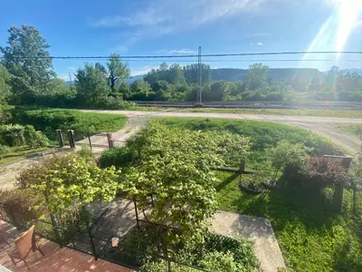 a garden with a fence and plants in a field at Vila Una 1 in Ripač