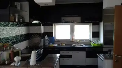 a kitchen with a sink and a window at Vila Una 1 in Ripač