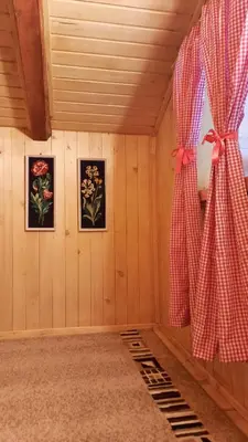 a room with a window with a red curtain at Etno selo EDEN in Žeravački Potok