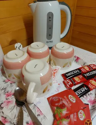 a table with a tea pot and a kettle and some candy at Etno selo EDEN in Žeravački Potok